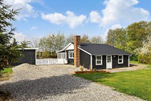 a small house with a gravel driveway in front of it at LF15081-Farso-Illeris-121 in Farsø