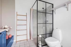 a bathroom with a toilet and a glass shower at LF15081-Farso-Illeris-121 in Farsø +21 photos