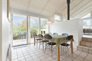 a dining room with a table and chairs at 84174-Knebel-Fuglsovig-301 in Knebel