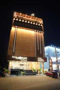 a building with a car parked in front of it at MOKSH SERENe in Shrīnagar
