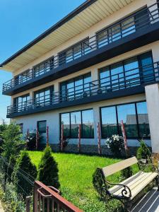 a building with a bench in front of it at pensiunea delta ideal in Sulina +5 photos