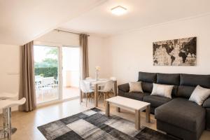 a living room with a couch and a table at Adosado Roldán by Rental Olé in Roldán