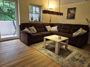a living room with a brown couch and a coffee table at Rügenglück in Breege