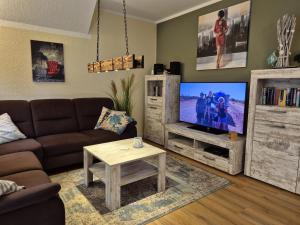 a living room with a couch and a tv at Rügenglück in Breege +16 photos