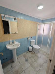 a bathroom with a sink and a toilet at AYAMONTE ROOMS 43 in Ayamonte