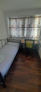 a room with a bed and a desk and a window at Ela Gar 3 WG Zimmer in Garsten