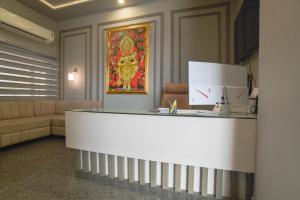 a lobby with a reception desk and a couch at Shivashish Resort in Indore