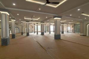 an empty room with columns in a building at Shivashish Resort in Indore