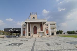 a building with a clock tower on top of it at Shivashish Resort in Indore