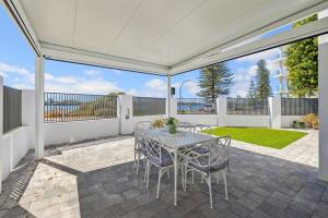 a patio with a table and chairs on a patio at Riverfront on The Esplanade 3BDR in Perth