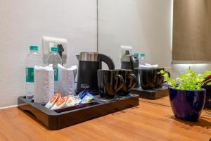 a counter with two bottles of water and some food at Hotel Velocity Near Terminal 3 Delhi International Airport With- Free Pickup in New Delhi +17 photos