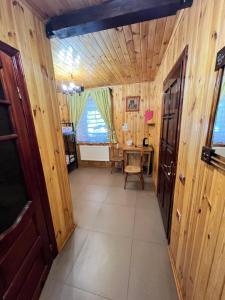a hallway with a table in a room with wooden walls at Serce Kanyonu in Kamianets-Podilskyi