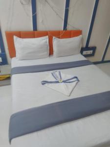 a pair of beds with a clock on them at hotel v heritage in Surat