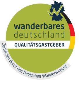 a sign with the words wanders deutschland with a rainbow at Ferienwohnung Baumkrone in Waldeck