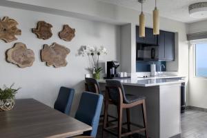 a kitchen and dining room with a table and chairs at Beach Villas in Stuart