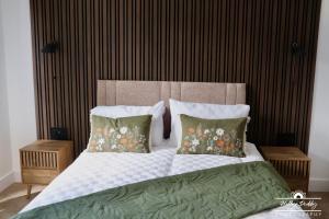 a bedroom with a bed with pillows and a headboard at The Kings Arms Hotel, Lostwithiel in Lostwithiel