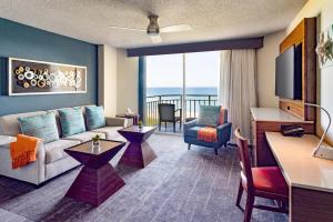 a living room with a couch and a table at Beach Villas in Stuart
