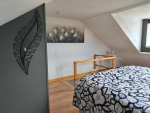 a bedroom with a bed in a attic at The Colored Butterfly in Månstad