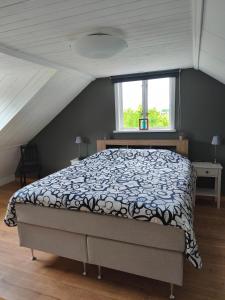 a bedroom with a bed and a window at The Colored Butterfly in Månstad