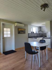 a room with a table and chairs and a kitchen at The Colored Butterfly in Månstad