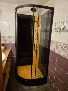 a shower with a glass door in a bathroom at Les Vergers d'Epona "Fremifontaine VOSGES" in Frémifontaine +14 photos