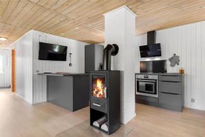 a living room with a fireplace in a kitchen at C11213-Hemmet-Alpehuen-4 in Hemmet +29 photos