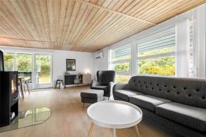 a living room with a couch and a table at C11213-Hemmet-Alpehuen-4 in Hemmet