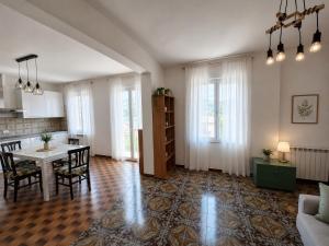 a living room with a table and a kitchen at Agata Agnese Homes in Carlazzo +10 photos