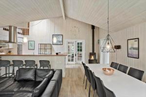 a living room and kitchen with a table and a couch at M191-Vaeggerlose-Baeverstien-46 in Bøtø By