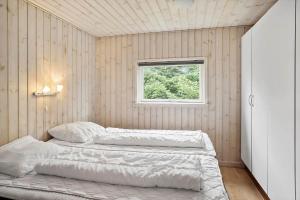 a bedroom with two beds and a window at M191-Vaeggerlose-Baeverstien-46 in Bøtø By +22 photos