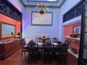 a dining room with a table and chairs and a chandelier at LocoAmor in Montevideo