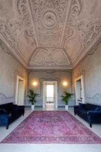 a large room with a ceiling and a large rug at Palazzo Galluccio in Galatina +55 photos