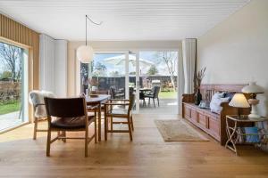 a dining room with a table and chairs at 30111-Odder-Lundgaardsvej-7 in Odder