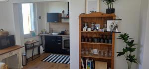 a kitchen and a living room with a book shelf at Cozy city appartement in Forchheim +24 photos