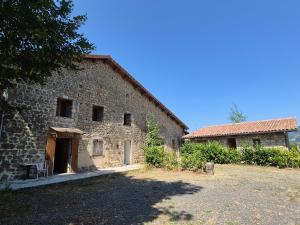 an old stone building with a yard in front of it at Studio Beau rêve in Le Cheylard