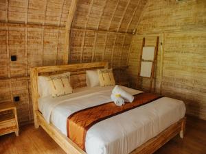 a bedroom with a bed in a bamboo room at Griyani Homestay in Uluwatu