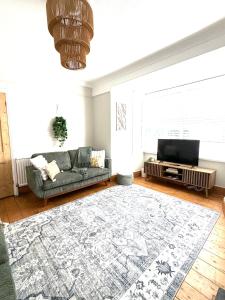 a living room with a couch and a flat screen tv at Joshua House in Newquay +38 photos
