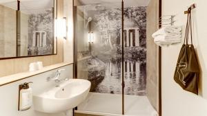 a bathroom with a sink and a shower at Campanile NATURE - Moulins Avermes in Avermes