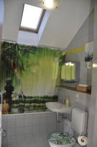 a bathroom with a sink and a toilet and a window at Ferienwohnung Wildgatter in Grafenwiesen +49 photos