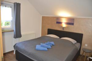 a bedroom with a bed with blue towels on it at Ferienwohnung Wildgatter in Grafenwiesen
