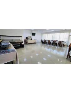 a large room with chairs and a room with a table at pensiunea delta ideal in Sulina