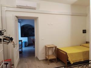 a room with a bed and a room with a hallway at Casa di nonna Caterina in Nemoli
