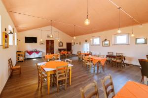 an empty dining room with tables and chairs at Villa Podere 109 - BioWine in Alberese