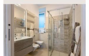 a bathroom with a shower and a toilet and a sink at Residenza Jasmine in Verbania +40 photos