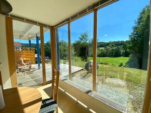 a room with a large window looking out at a yard at Apartment with Terrace & Garden View in Zwiesel