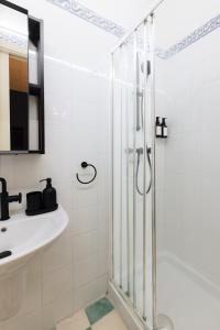 a bathroom with a shower and a sink at Ta' Dolor - Kalkara Heritage Maisonette in Kalkara +10 photos