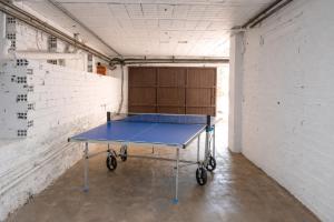 a ping pong table in a room with a wall at Majordoms Art in Sant Feliu de Pallerols