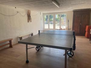 a ping pong table in the middle of a room at Hameau du HOUR - Chambres d'Hôtes et Gîtes dans le Gers in Béraut