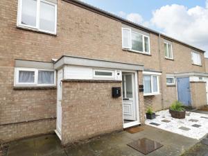 a brick house with a garage at Lodge Park in Corby