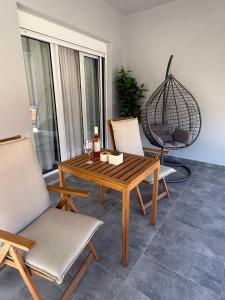 a wooden table and chairs in a living room at Angelos Studios in Ilia